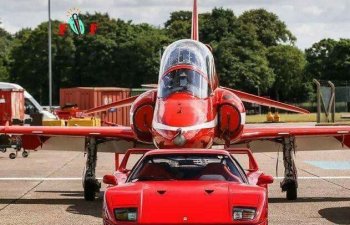 Ferrari standing in front of a jet aircraft